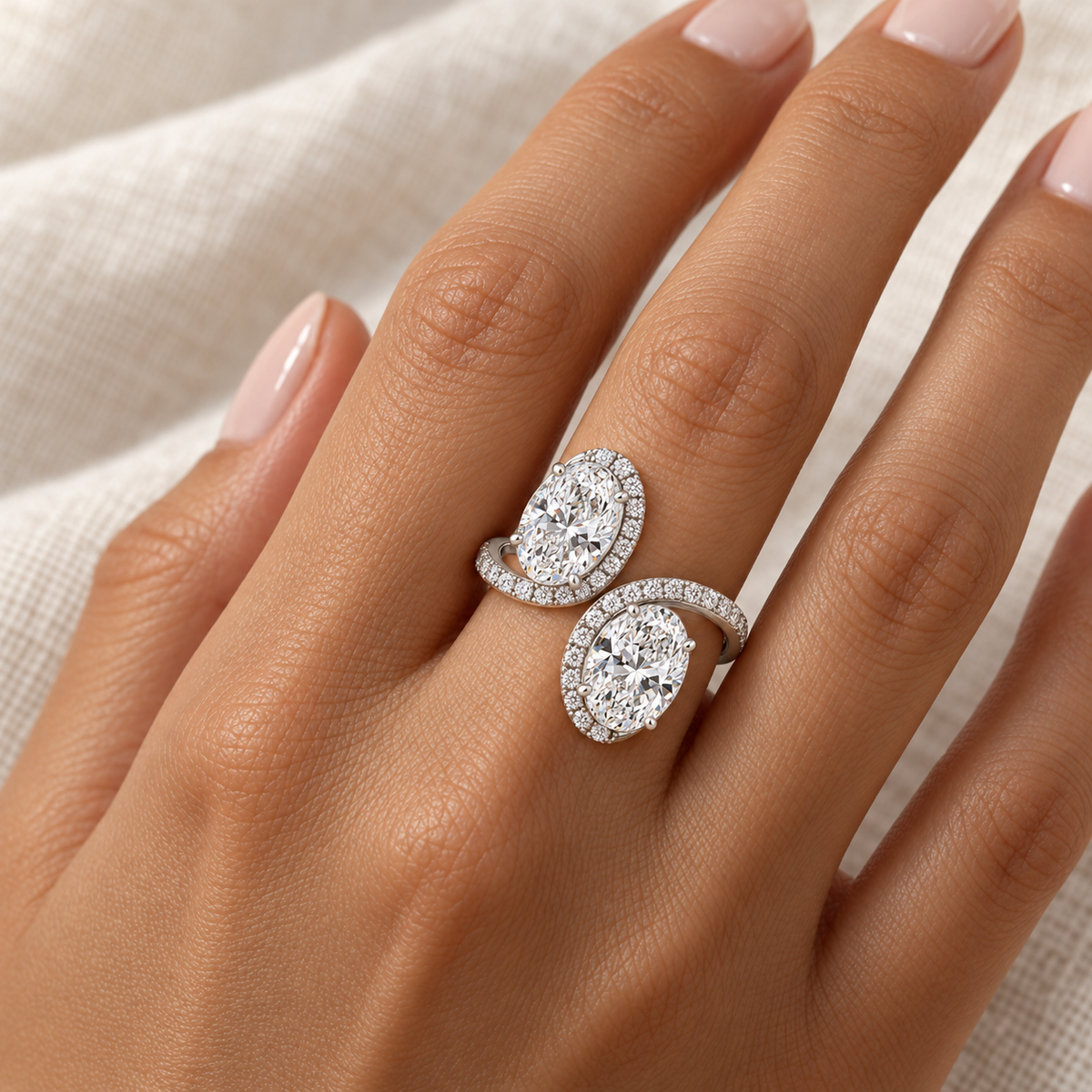 Oval Halo Toi et Moi Ring in 14K white gold worn on hand – illustrative rendering, approximate scale