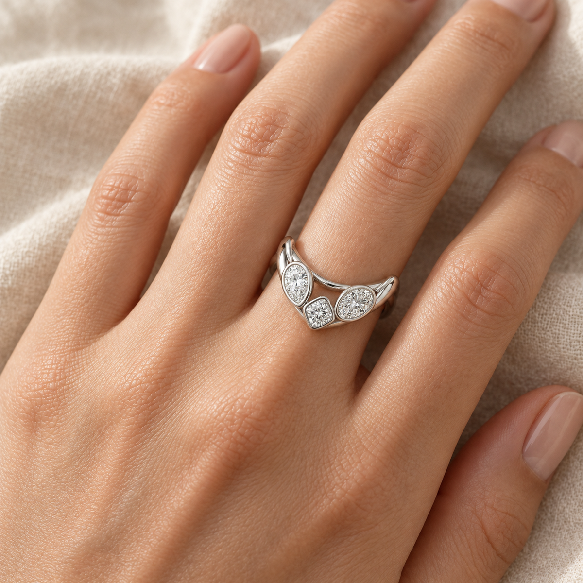 Three-Stone Bezel Contour Ring in 14K white gold worn on hand – illustrative rendering, approximate scale