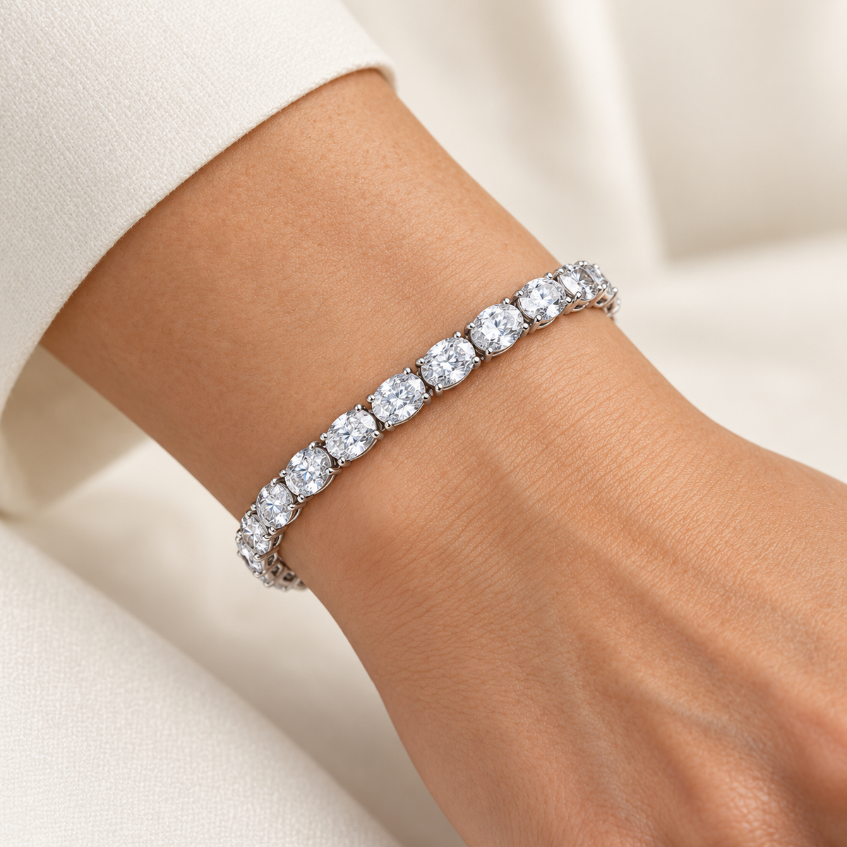 East-West Oval Tennis lab-grown diamond bracelet in 14K white gold, styled on a wrist — illustrative design rendering