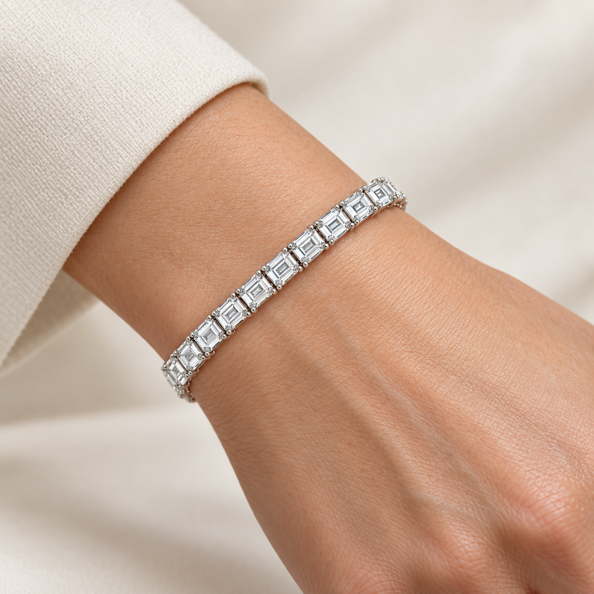 East-West Emerald Tennis lab-grown diamond bracelet in 14K white gold, styled on a wrist — illustrative design rendering