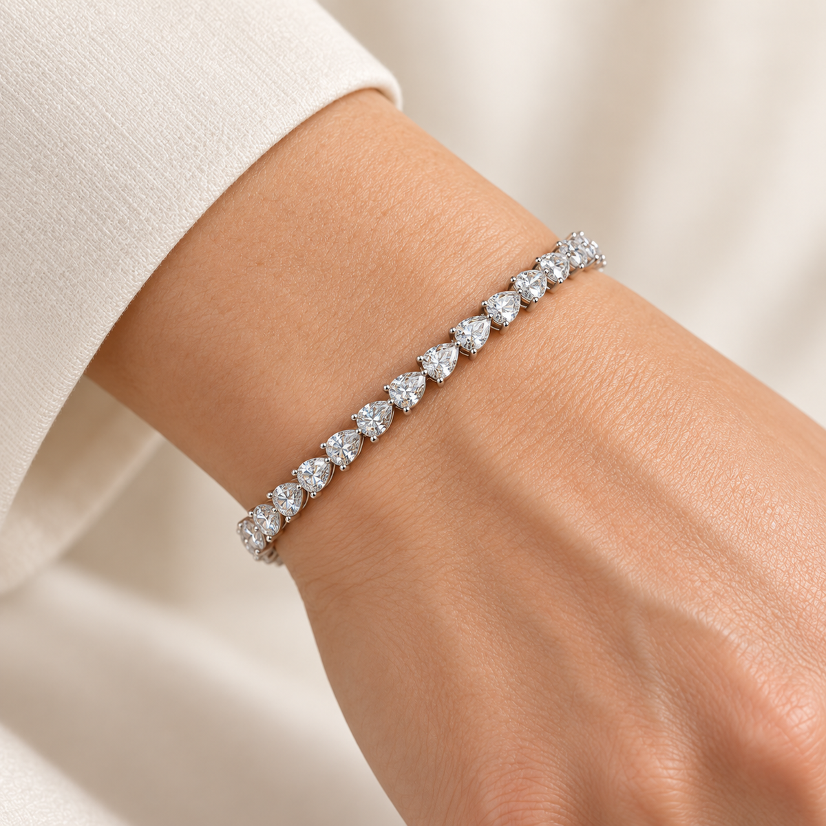 East-West Pear Tennis lab-grown diamond bracelet in 14K white gold, styled on a wrist — illustrative design rendering