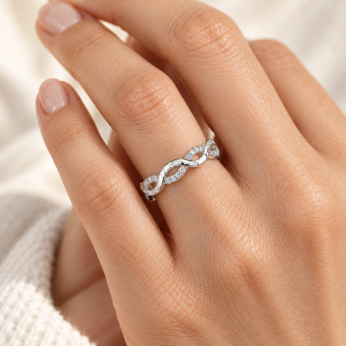 Infinity Twist lab-grown diamond eternity ring in 14K white gold, on-hand styling view — illustrative rendering