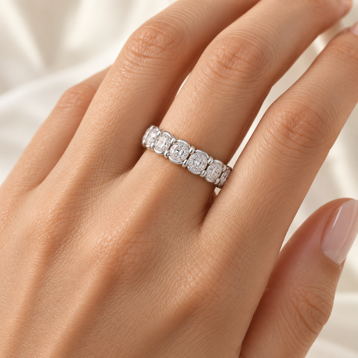 Oval Half-Bezel lab-grown diamond eternity ring in 14K white gold, on-hand styling view — illustrative rendering