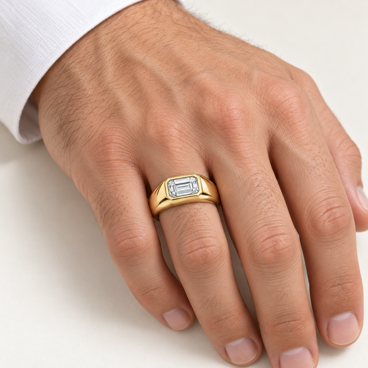 Men’s East-West Emerald Bezel Lab Diamond Signet — 2 CT in 14K yellow gold worn on a man's hand — AI-generated illustrative design rendering